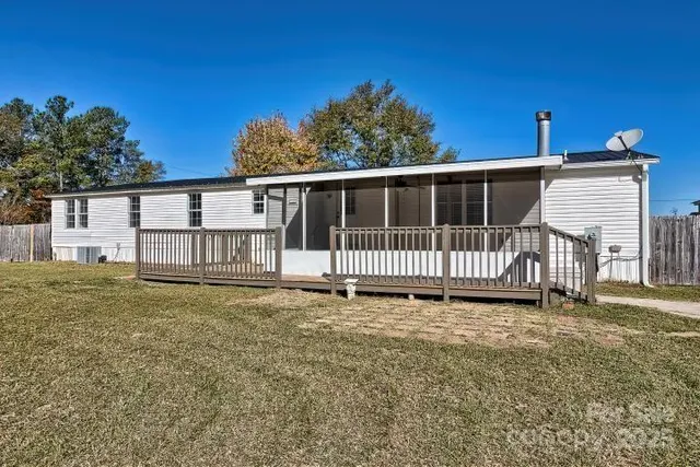 a view of a house with yard and deck