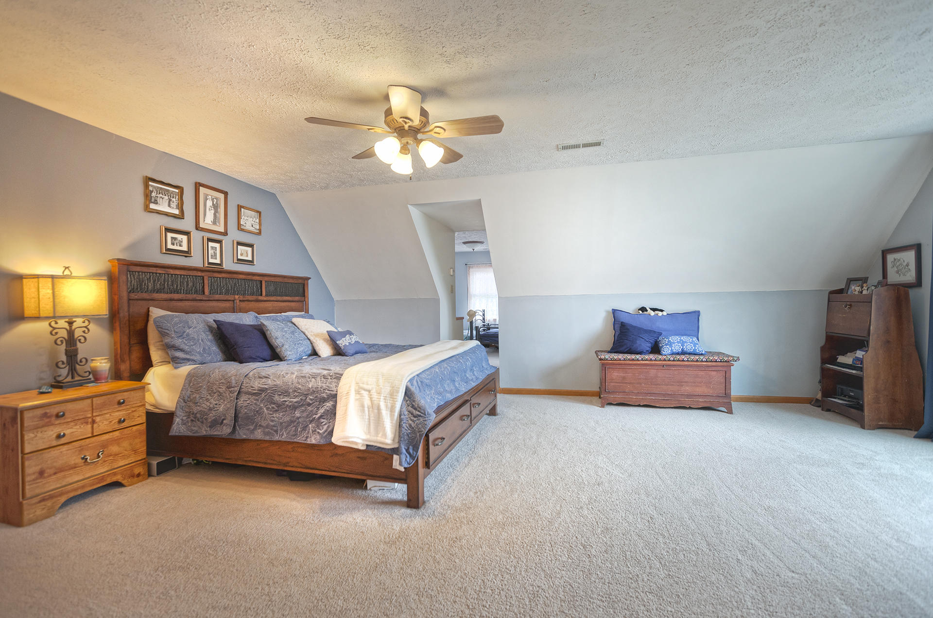 699 Highland Lake Road Union Hall, VA 24176 - Photo 15 of 33 a spacious bedroom with a bed and a chandelier