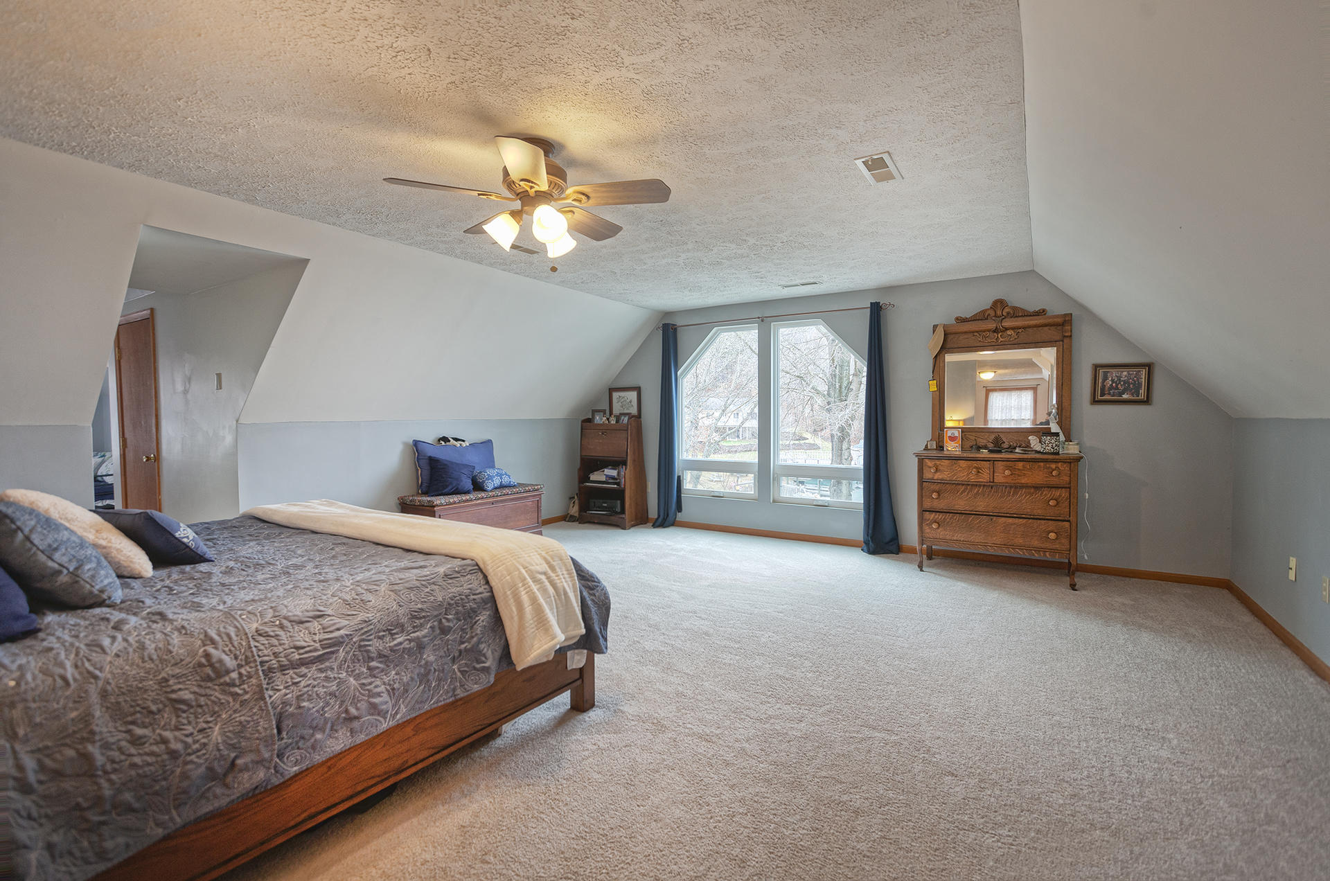 699 Highland Lake Road Union Hall, VA 24176 - Photo 18 of 33 a spacious bedroom with a bed and a large window