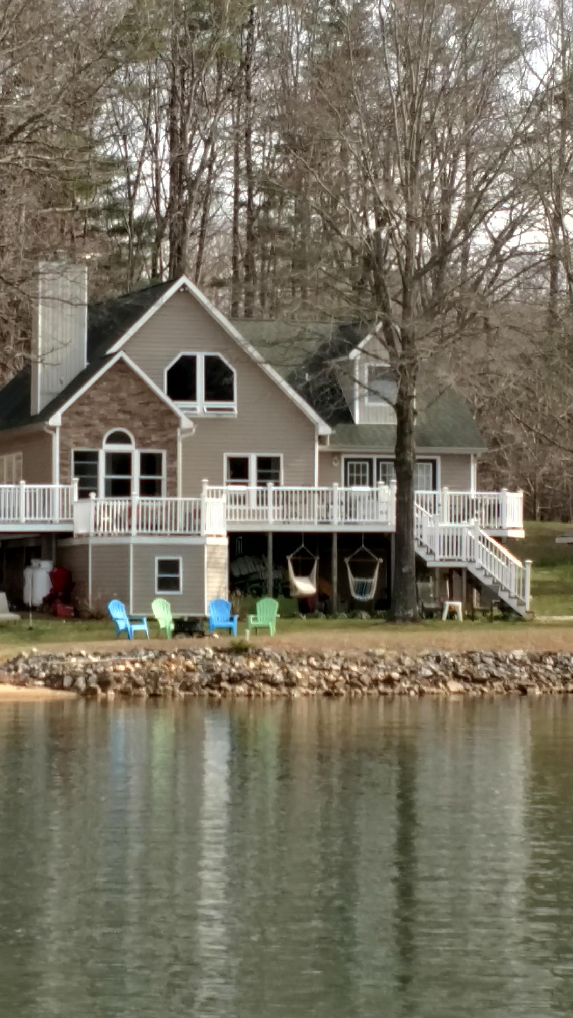 699 Highland Lake Road Union Hall, VA 24176 - Photo 30 of 33 a white house with a large pool next to a road with large trees