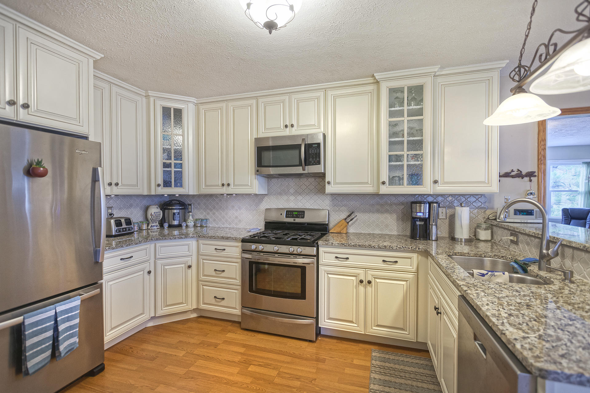 699 Highland Lake Road Union Hall, VA 24176 - Photo 4 of 33 a kitchen with granite countertop a stove top oven sink and cabinets