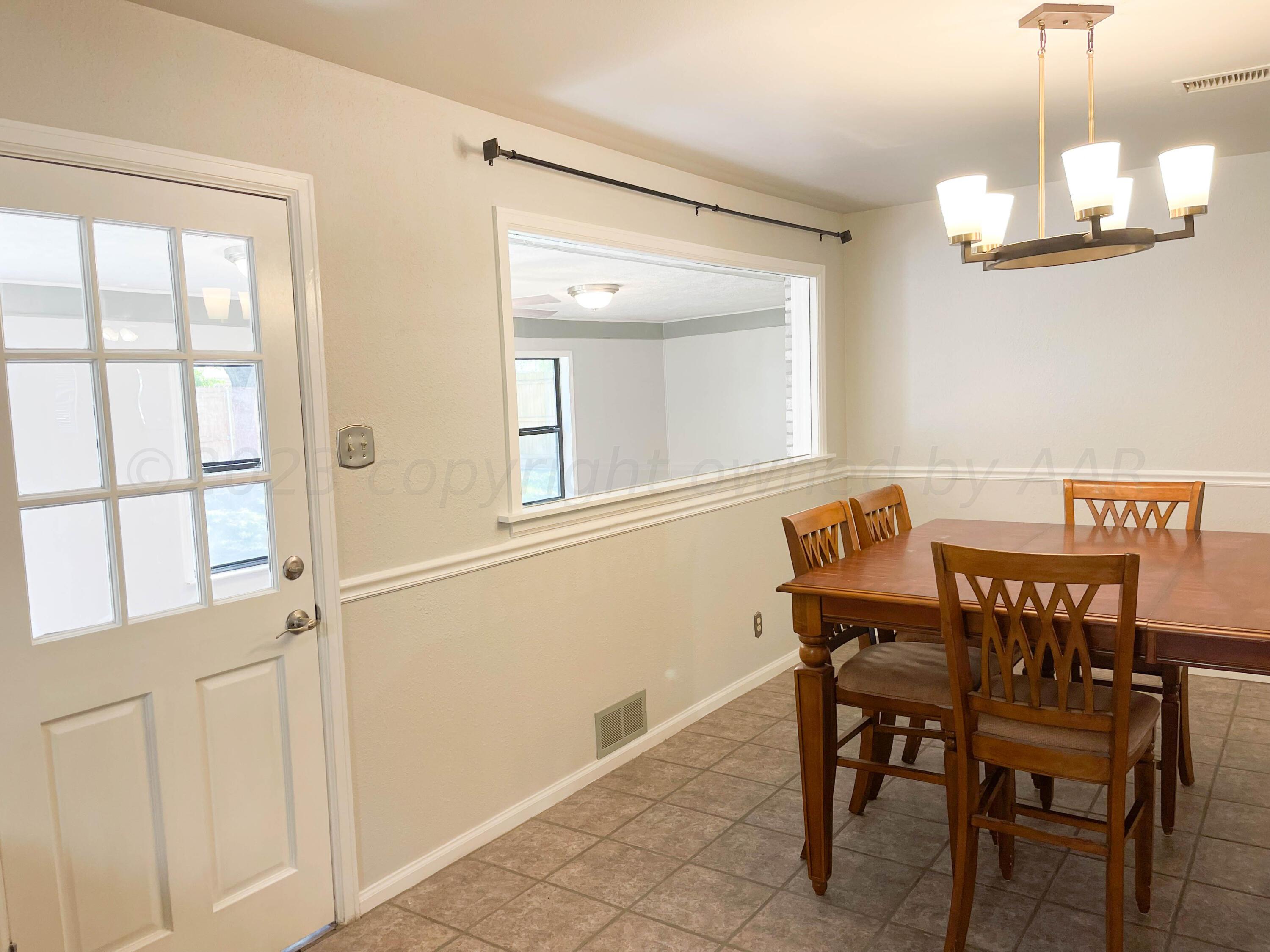 3707 Lynette Drive Amarillo, TX 79109 - Photo 14 of 45 a view of a dining room with furniture and a chandelier