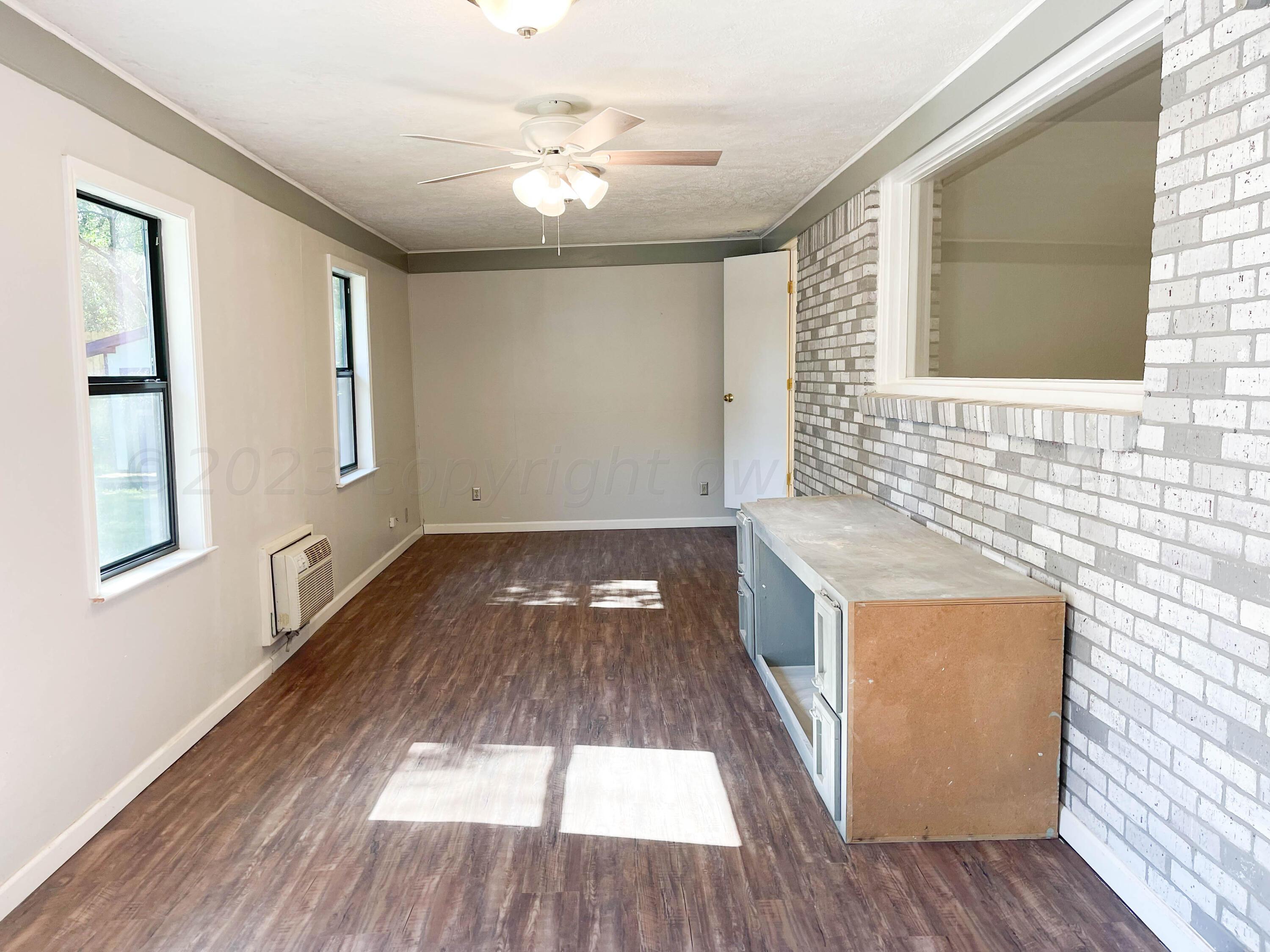 3707 Lynette Drive Amarillo, TX 79109 - Photo 17 of 45 wooden floor in an empty room with a window