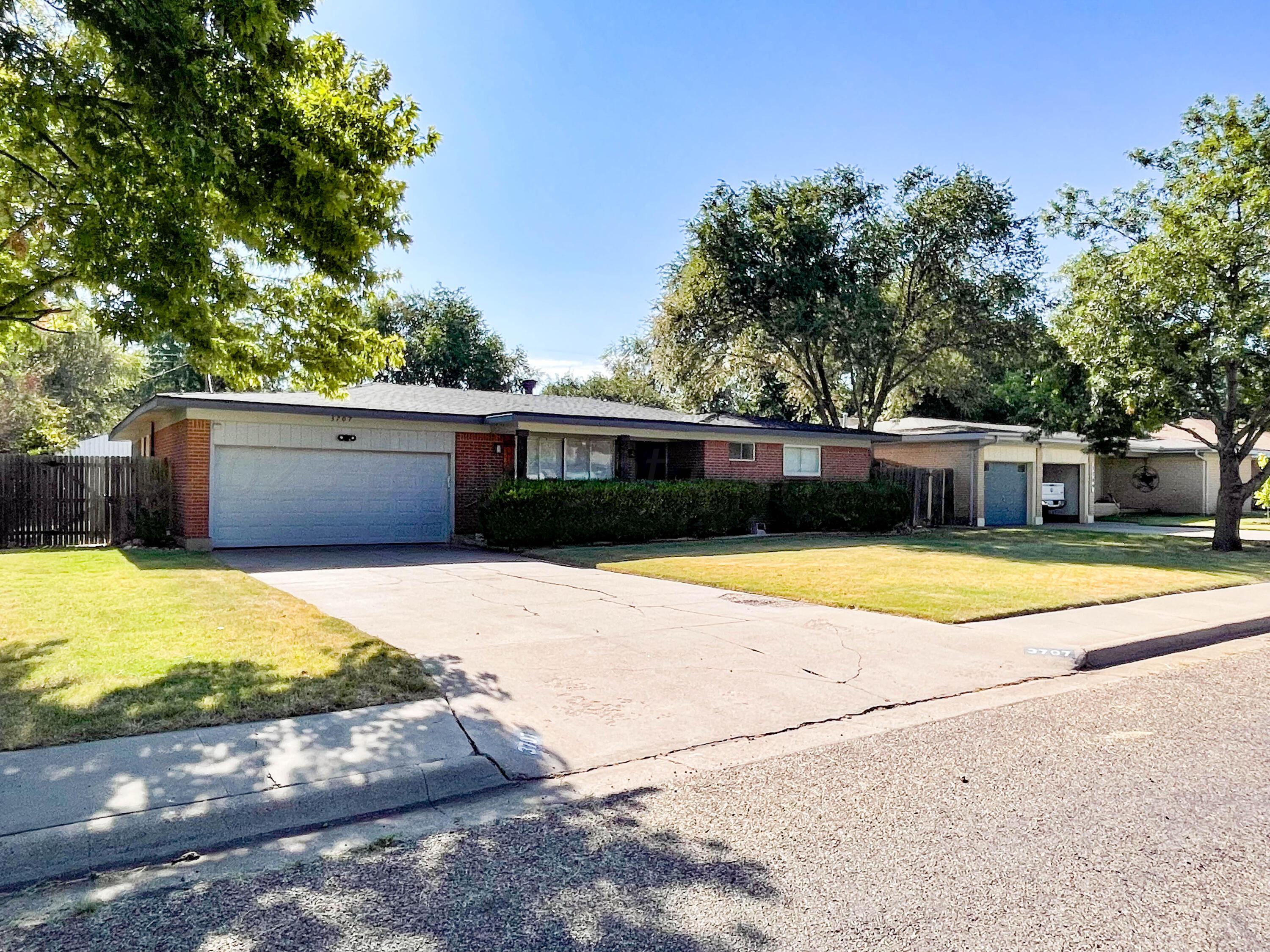 3707 Lynette Drive Amarillo, TX 79109 - Photo 2 of 45 a view of a swimming pool with a yard