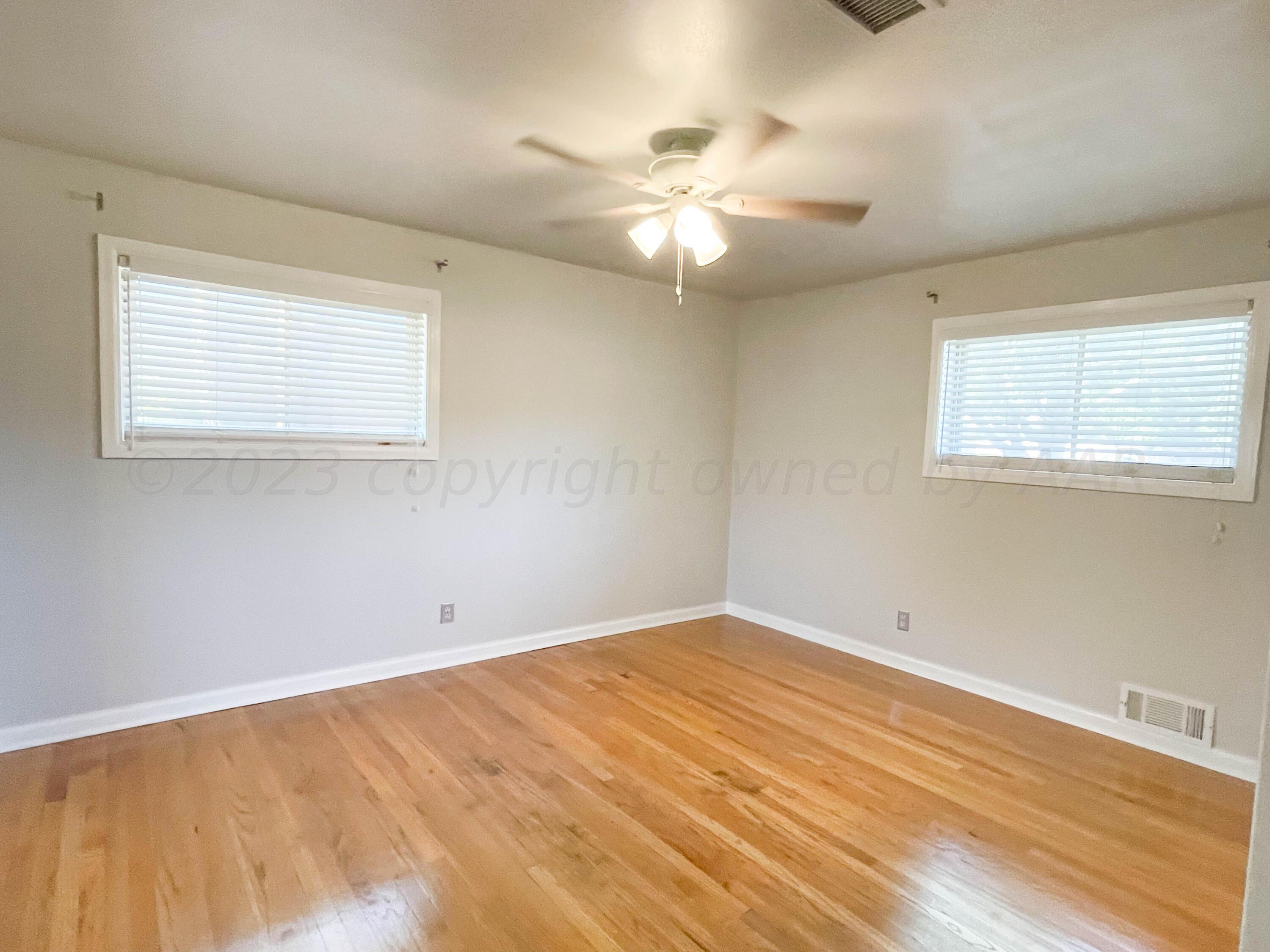 3707 Lynette Drive Amarillo, TX 79109 - Photo 24 of 45 a view of an empty room with wooden floor and a window