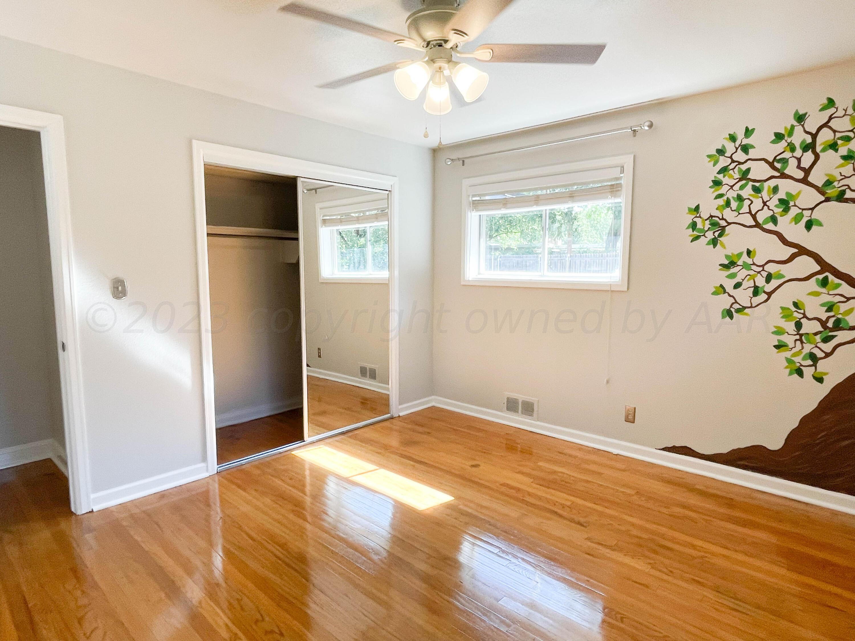 3707 Lynette Drive Amarillo, TX 79109 - Photo 30 of 45 a view of an empty room with wooden floor and a window