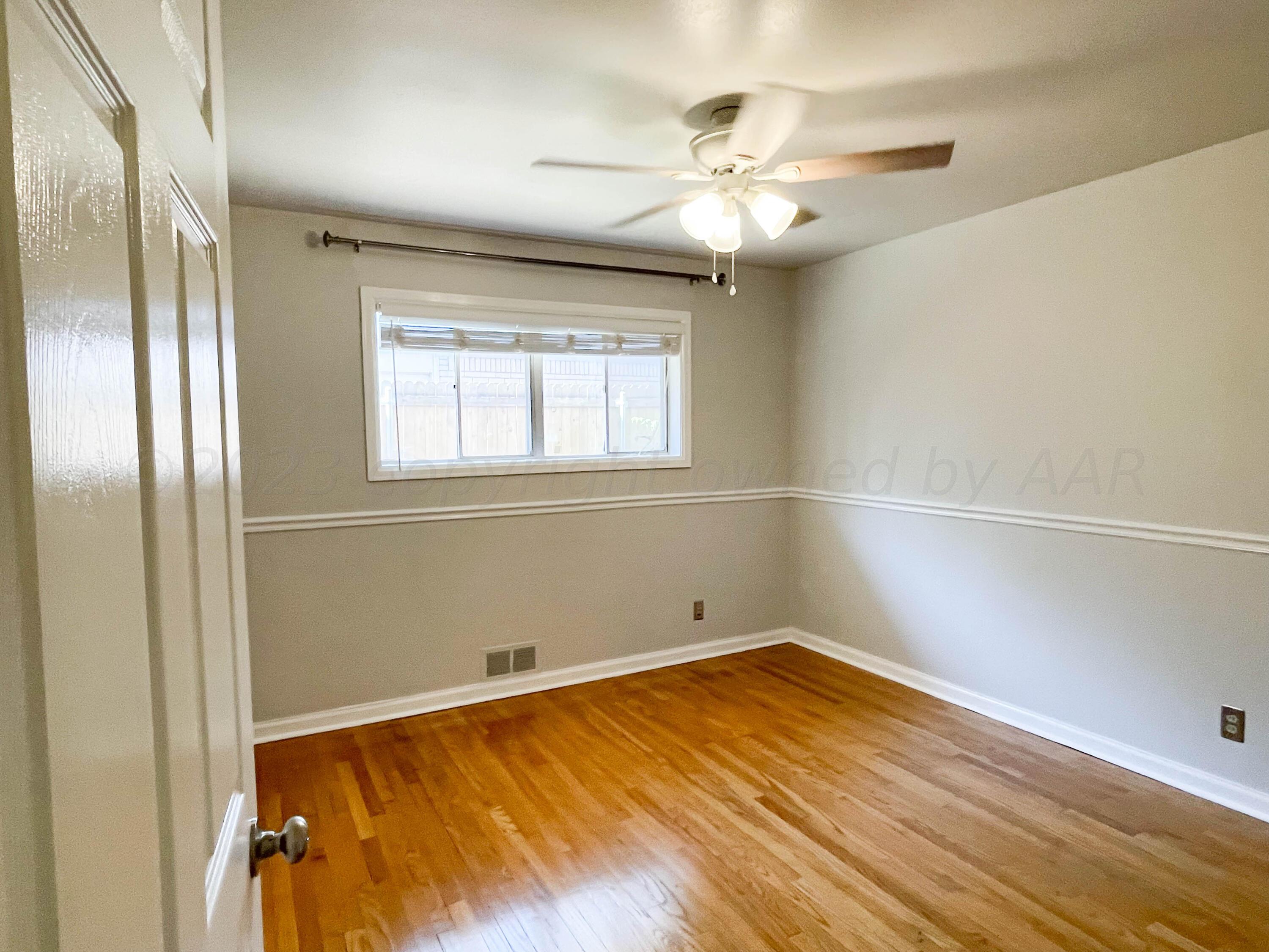 3707 Lynette Drive Amarillo, TX 79109 - Photo 32 of 45 a view of empty room with wooden floor and fan