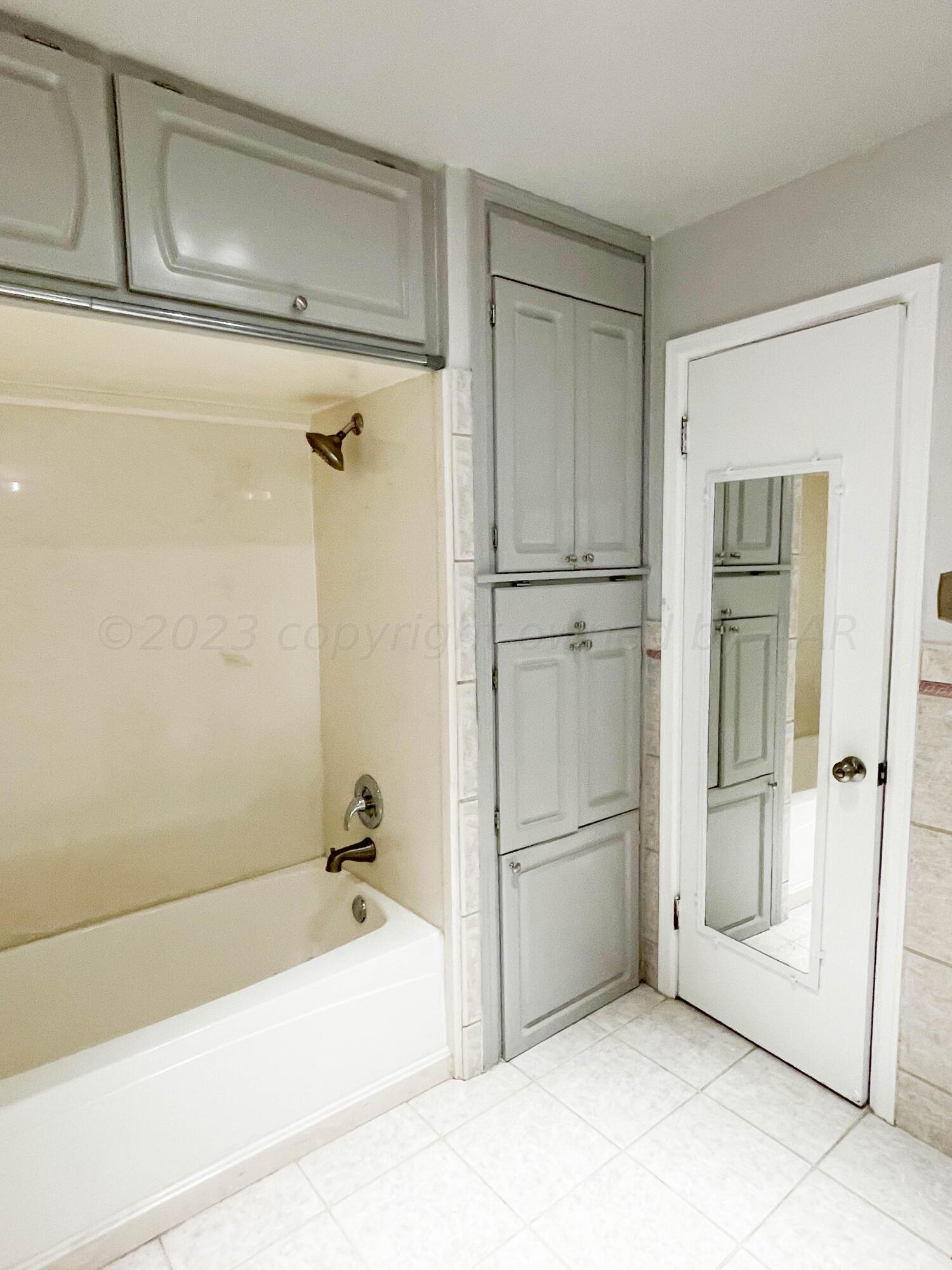 3707 Lynette Drive Amarillo, TX 79109 - Photo 36 of 45 a bathroom with a bathtub and a shower