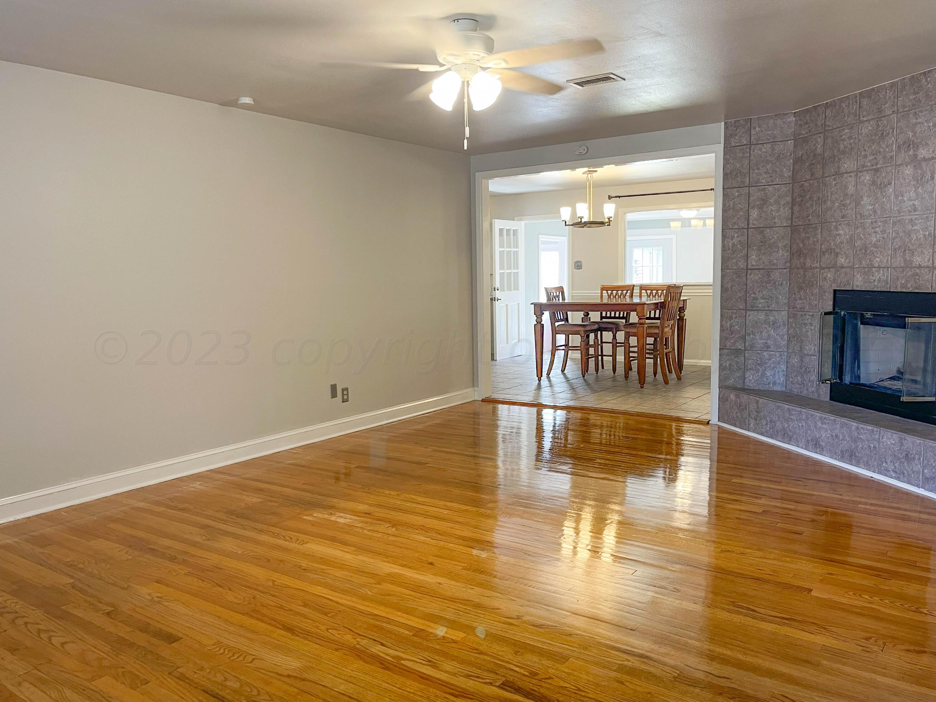 3707 Lynette Drive Amarillo, TX 79109 - Photo 4 of 45 a view of empty room with wooden floor and fan