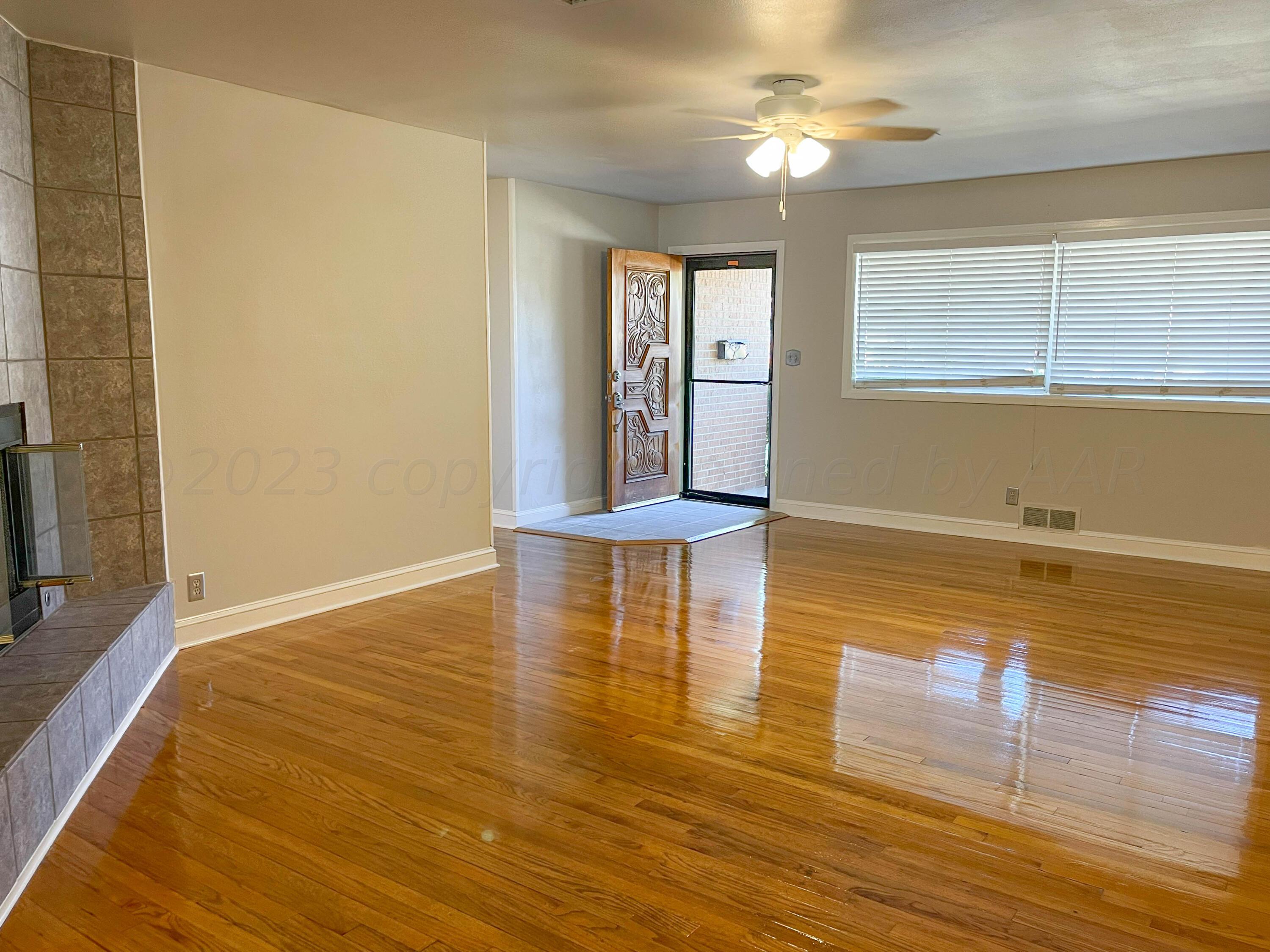 3707 Lynette Drive Amarillo, TX 79109 - Photo 5 of 45 a view of empty room with wooden floor and fan