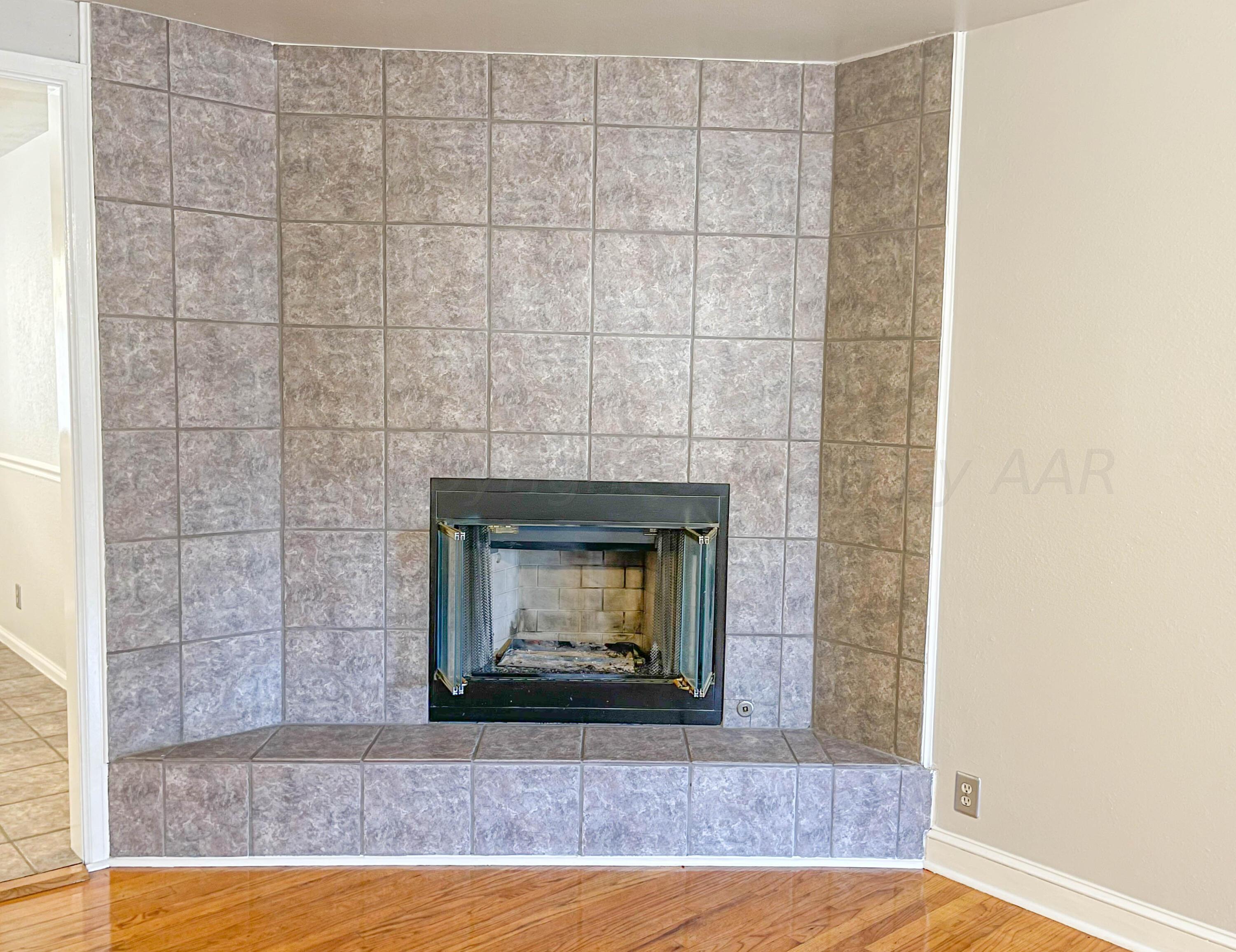 3707 Lynette Drive Amarillo, TX 79109 - Photo 7 of 45 a view of an empty room with wooden floor and a fireplace