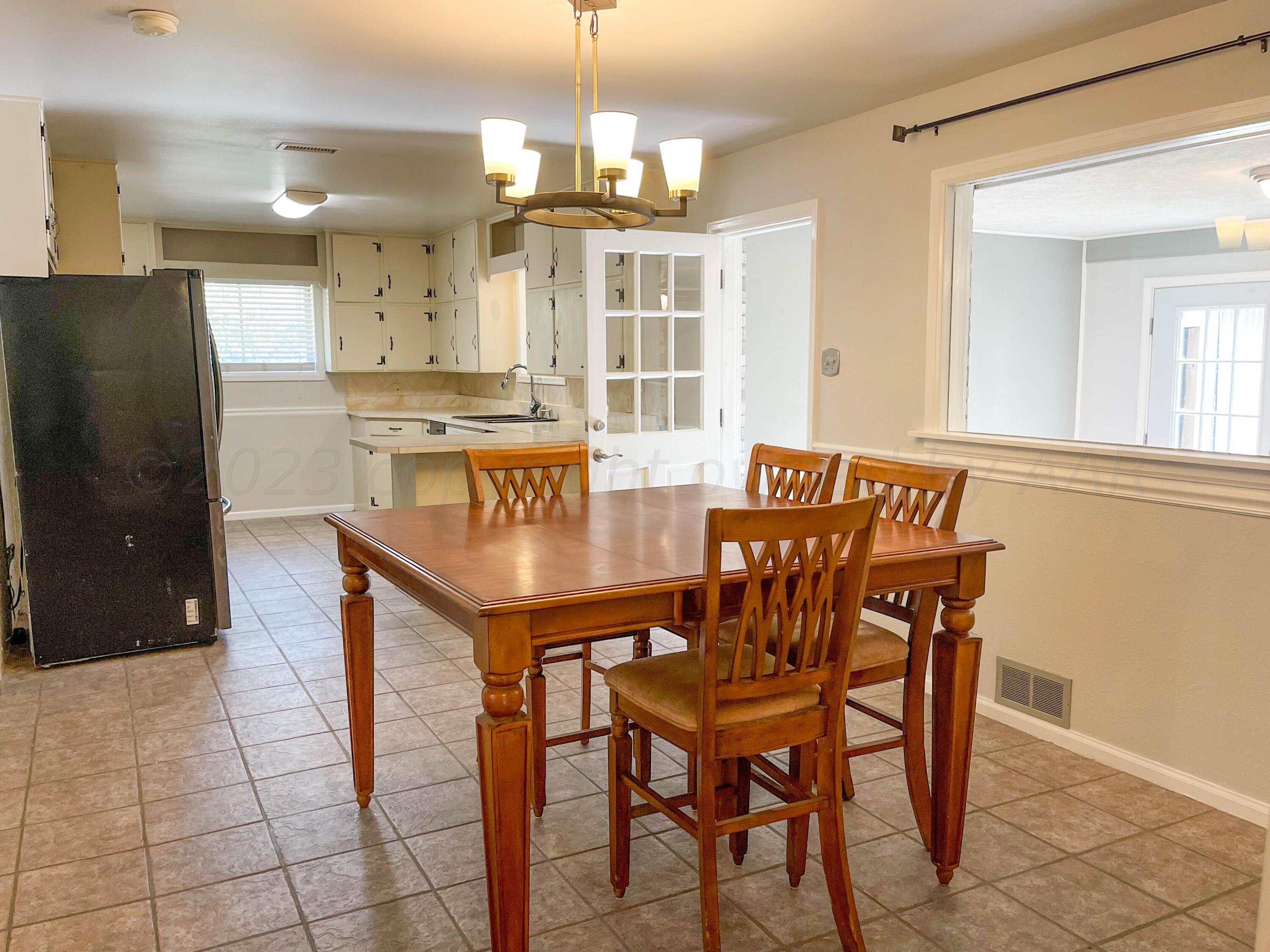 3707 Lynette Drive Amarillo, TX 79109 - Photo 8 of 45 a view of a dining room with furniture and chandelier