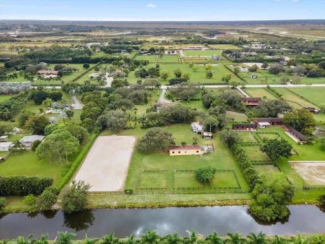 an aerial view of a houses with a yard