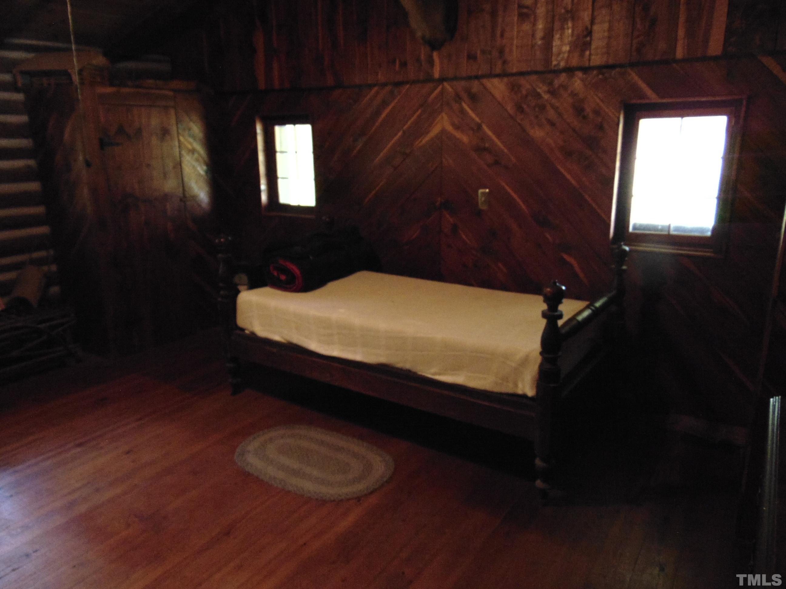 1150 Tungsten Mine Road Bullock, NC 27507 - Photo 8 of 14 a bed sitting in a bedroom next to a window
