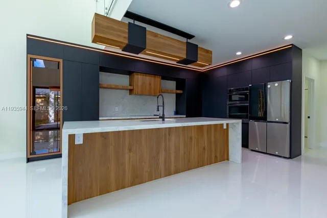 a kitchen with stainless steel appliances a sink and cabinets