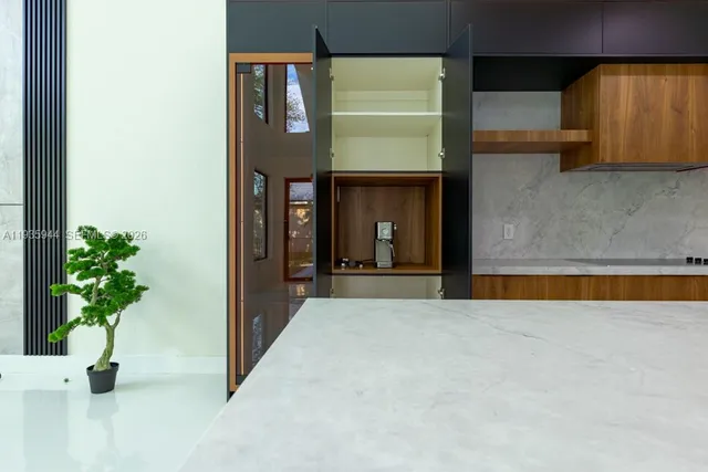 a kitchen with stainless steel appliances kitchen island a chandelier