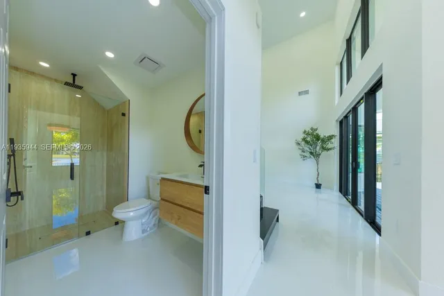a spacious bathroom with a double vanity sink mirror and bathtub