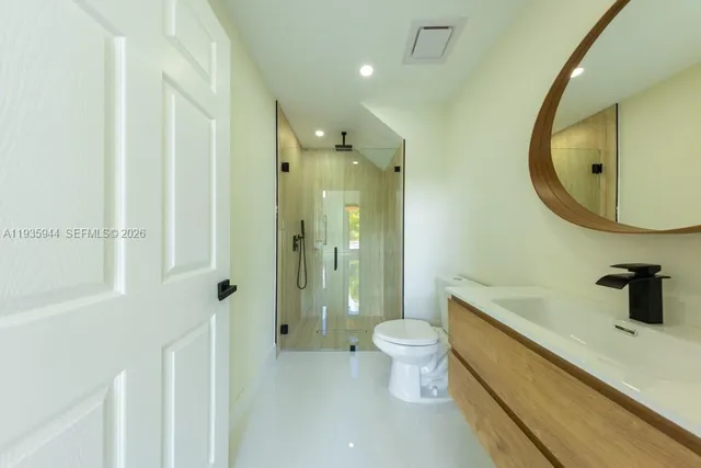 a bathroom with double vanity sinks and a mirror