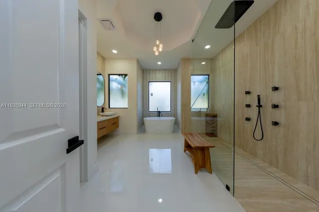 a bathroom with a double vanity sink toilet mirror and bathtub