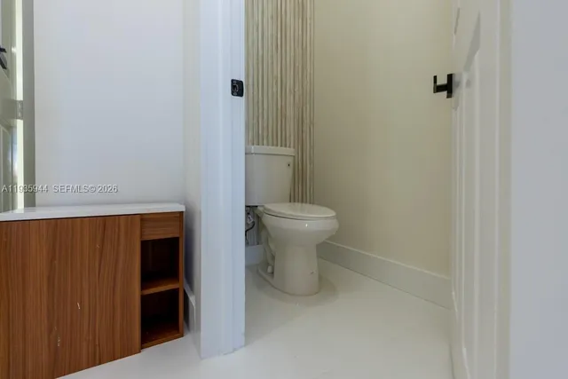 an empty room with closet and a bathroom