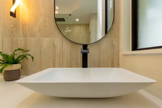 a bathroom with a toilet a sink and mirror