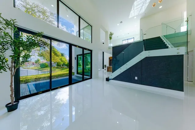 a kitchen with stainless steel appliances granite countertop a refrigerator and a stove