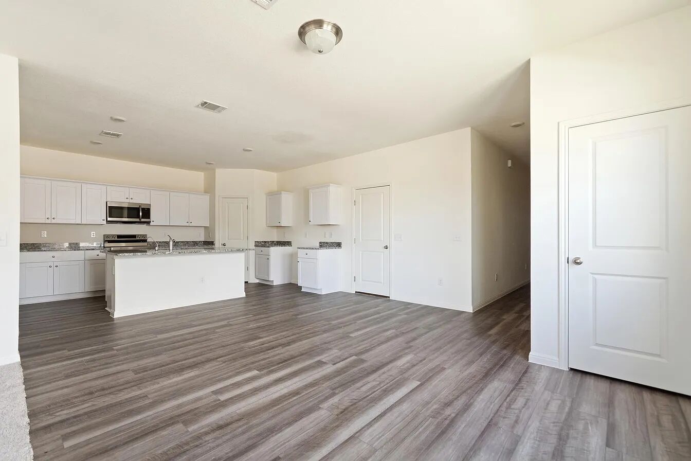 101 Aoudad Road Hutto, TX 78634 - Photo 11 of 39 A contemporary kitchen features bright white cabinetry and an inviting island, perfect for casual dining.