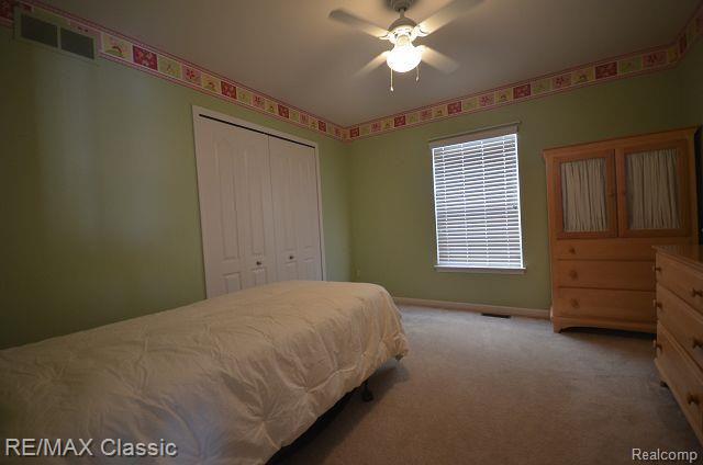 27458 Cromwell Road Novi, MI 48374 - Photo 27 of 39 Bedroom 3 with ceiling fan and large closet.