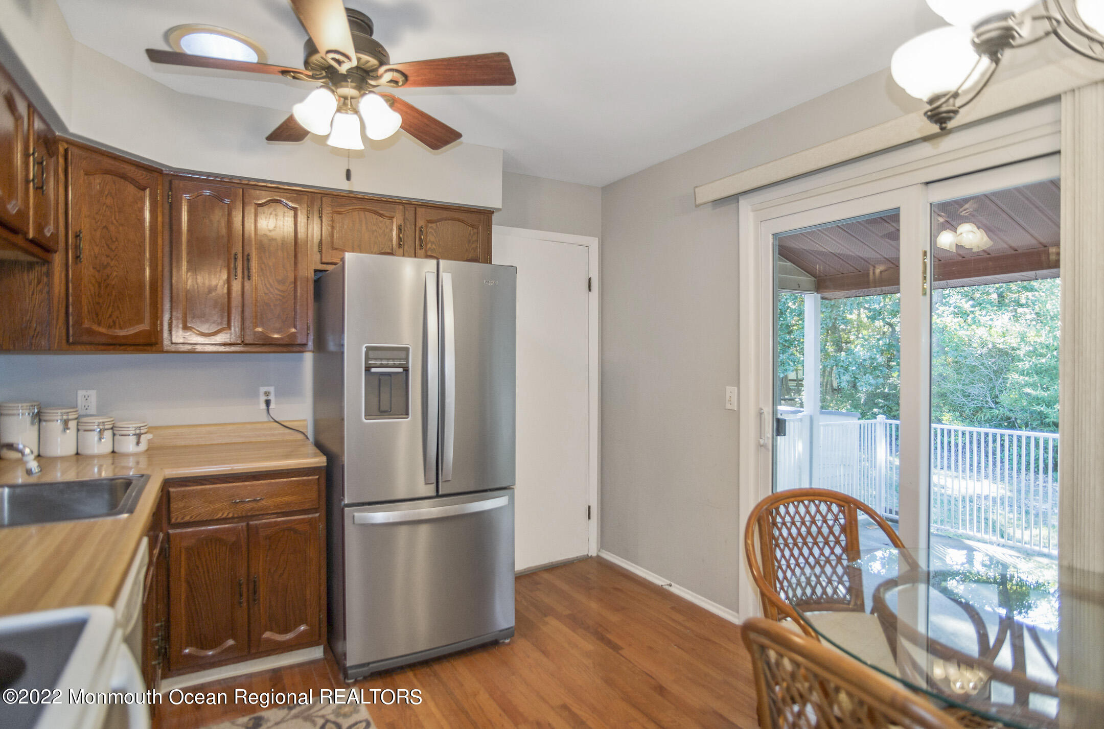 159 Sunset Road Whiting, NJ 08759 - Photo 10 of 22 a kitchen with stainless steel appliances granite countertop a refrigerator a stove a sink a dining table and chairs with wooden floor