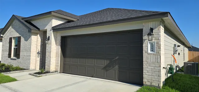 a front view of a house with garage