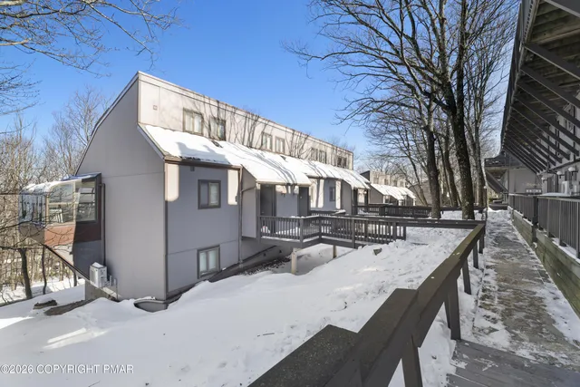 a view of a house with snow on the road
