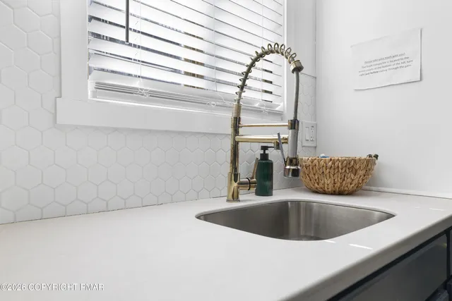 a kitchen with a sink and a window