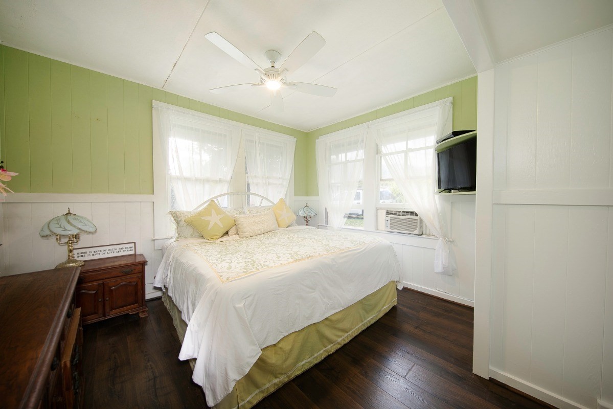 4368 Omao Road Koloa, HI 96756 - Photo 11 of 30 a bedroom with a bed and a flat tv screen on dresser