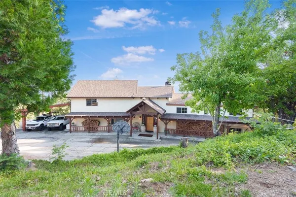 a house view with a sitting space and garden