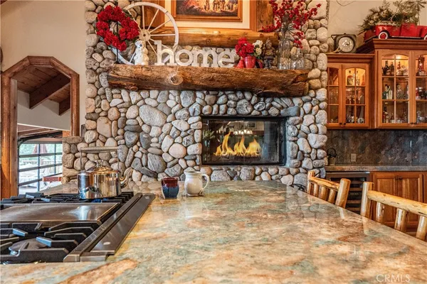 a kitchen with stainless steel appliances granite countertop a stove and a white cabinets