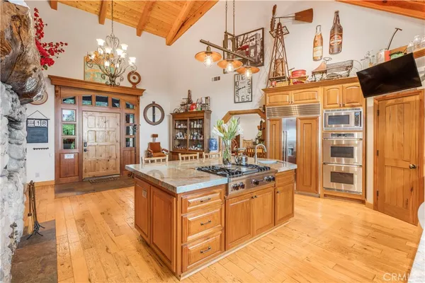 a kitchen with kitchen island granite countertop a sink and a counter top space
