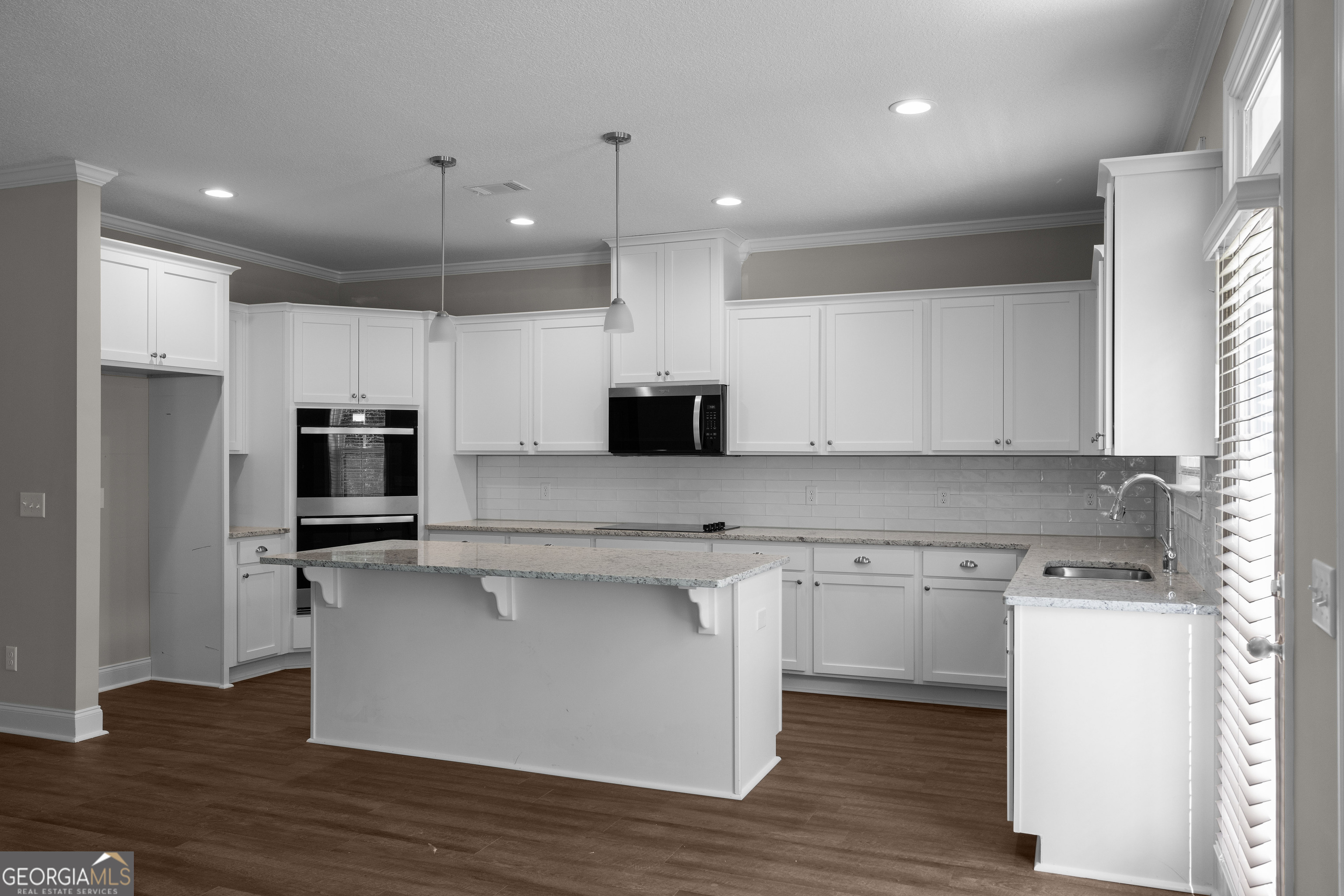 140 Watson Mill Road Guyton, GA 31312 - Photo 11 of 32 a kitchen with stainless steel appliances granite countertop a stove top oven a sink and a refrigerator