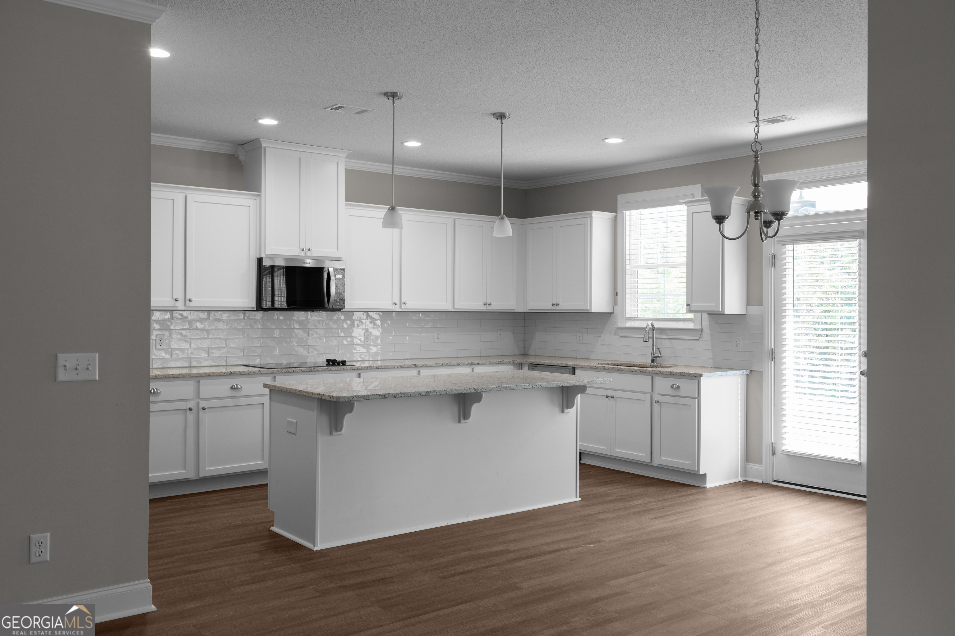 140 Watson Mill Road Guyton, GA 31312 - Photo 12 of 32 a kitchen with a sink cabinets and wooden floor