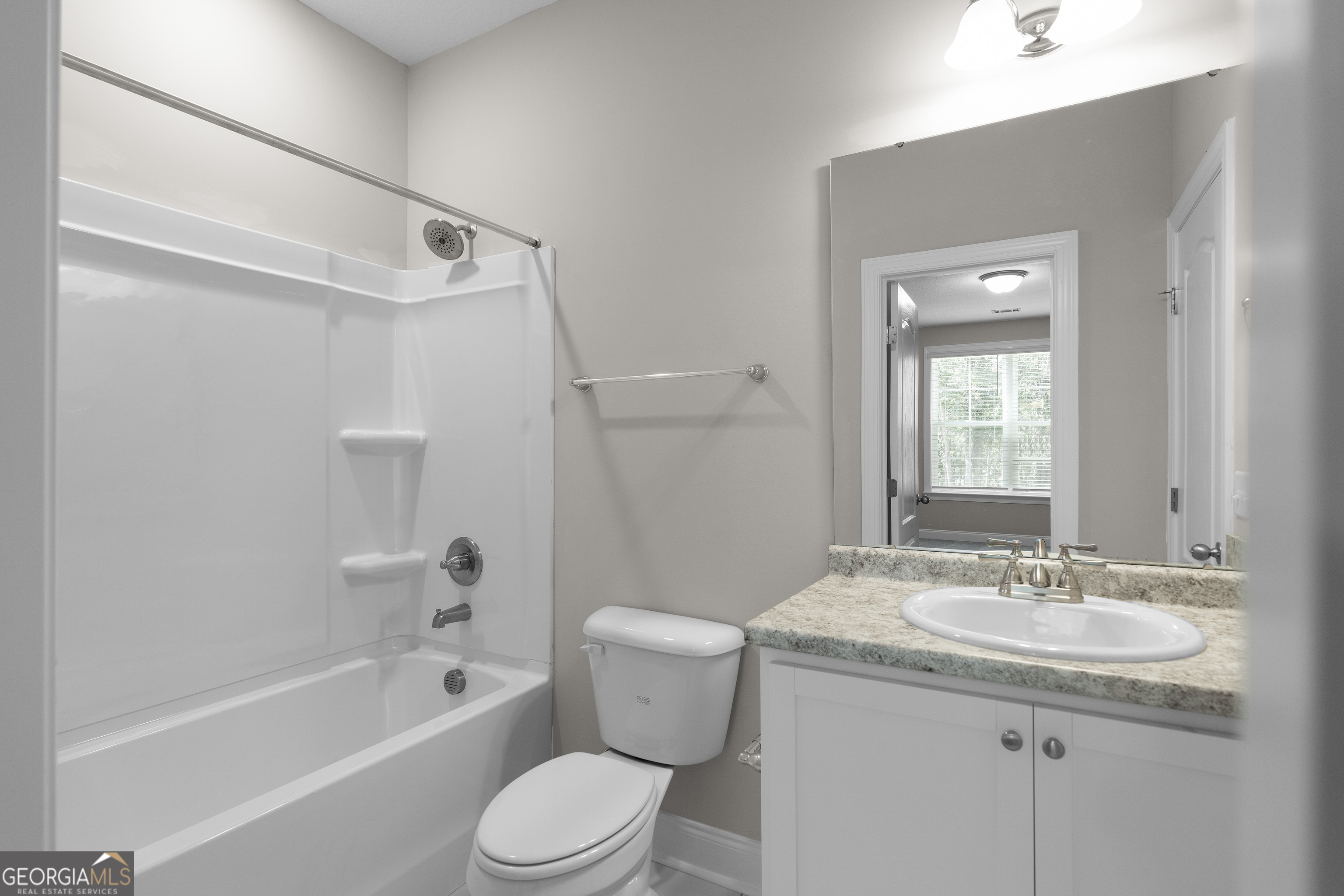 140 Watson Mill Road Guyton, GA 31312 - Photo 15 of 32 a bathroom with a granite countertop sink toilet and shower