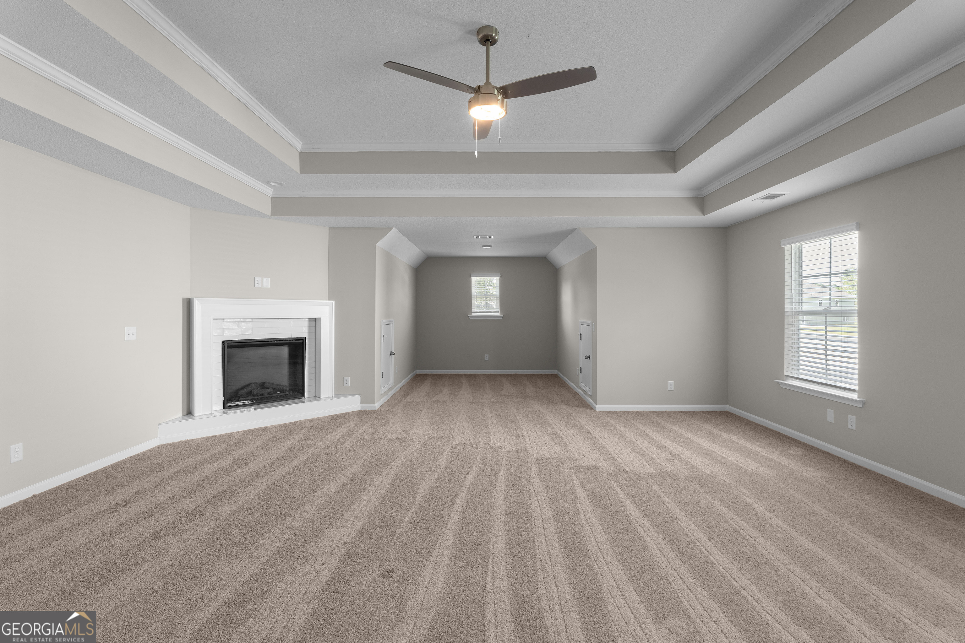 140 Watson Mill Road Guyton, GA 31312 - Photo 19 of 32 an empty room with windows and fireplace