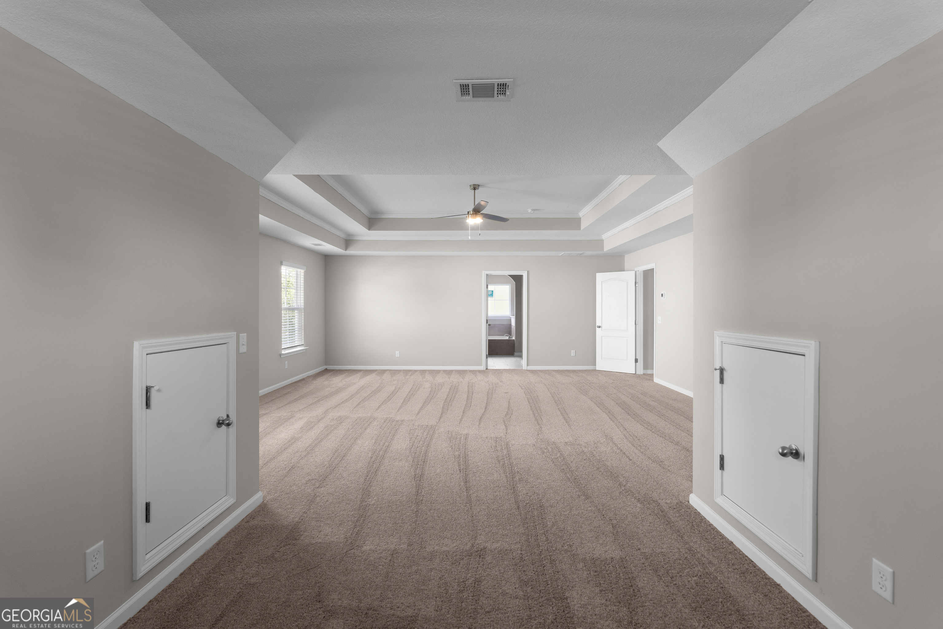 140 Watson Mill Road Guyton, GA 31312 - Photo 20 of 32 a view of empty room with wooden floor and fan