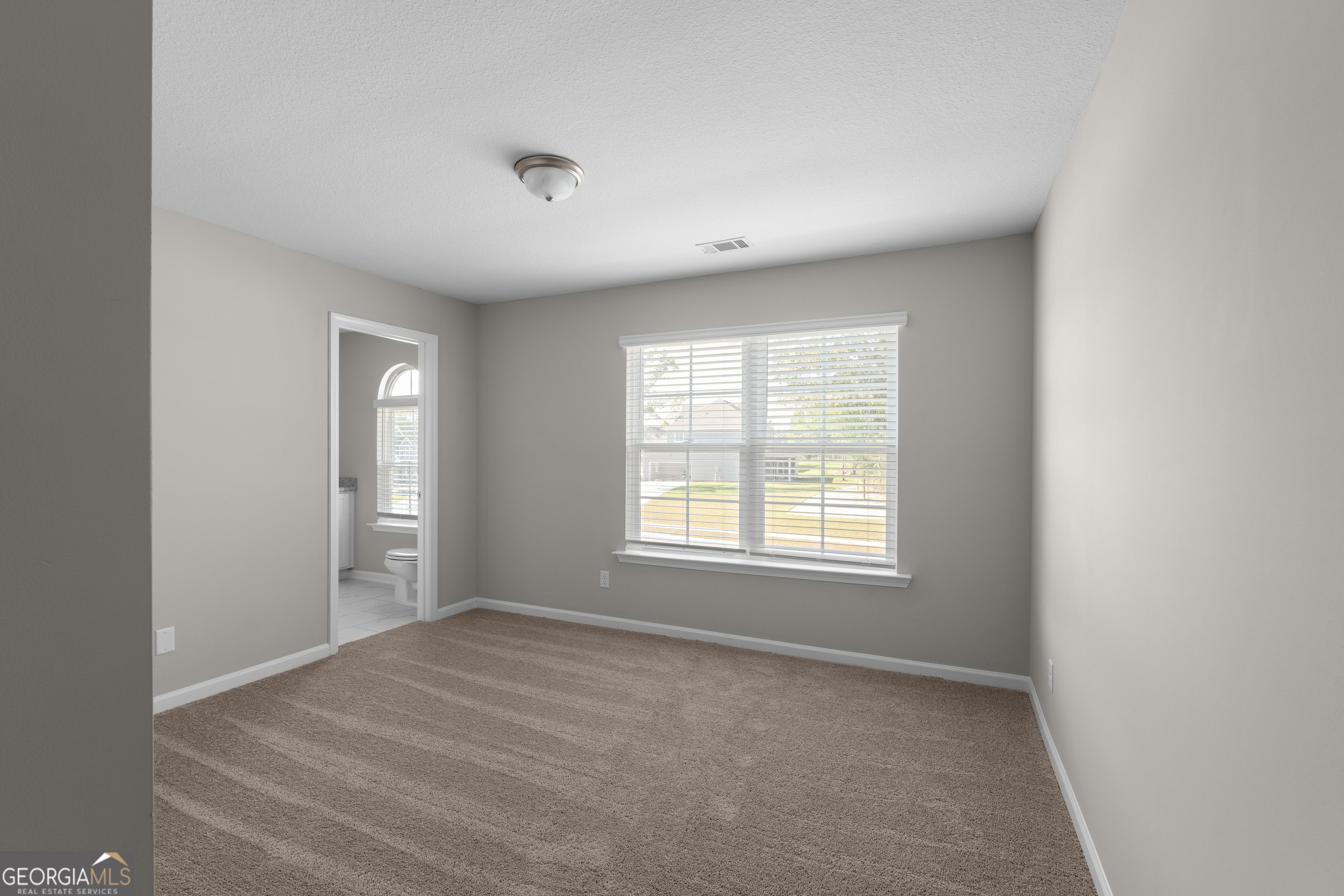 140 Watson Mill Road Guyton, GA 31312 - Photo 24 of 32 a view of an empty room with a window