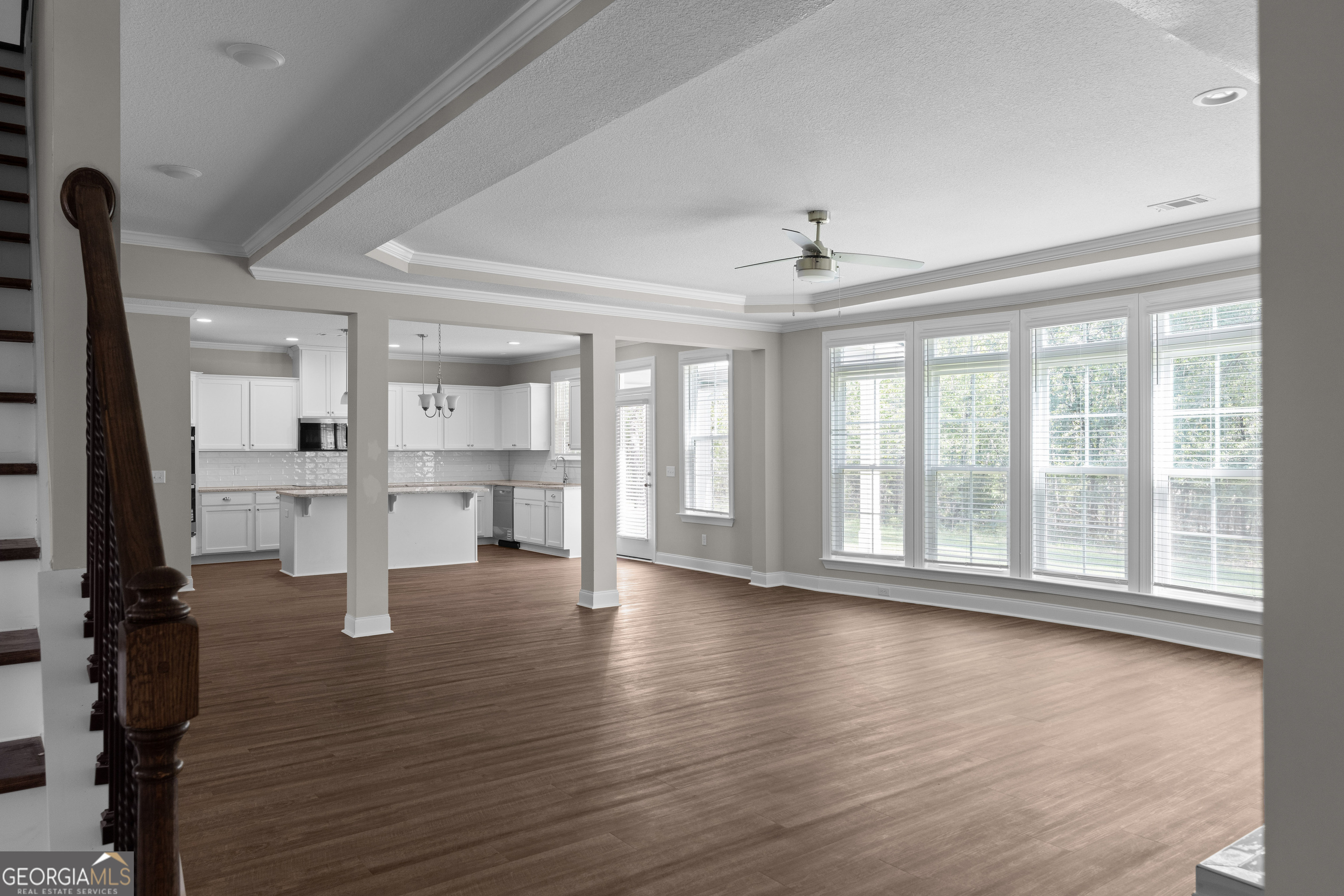 140 Watson Mill Road Guyton, GA 31312 - Photo 9 of 32 a view of an empty room with wooden floor and a window
