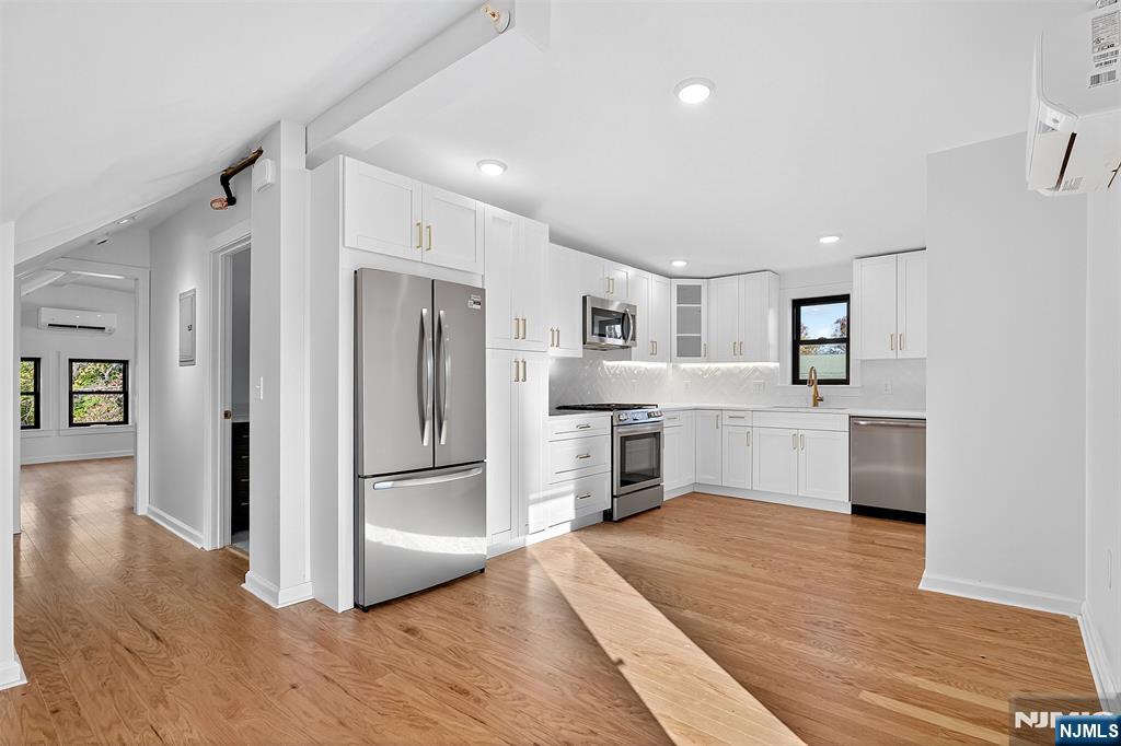 a kitchen with granite countertop a refrigerator and a sink
