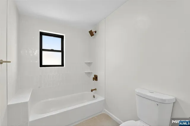 a bathroom with a bathtub and a toilet