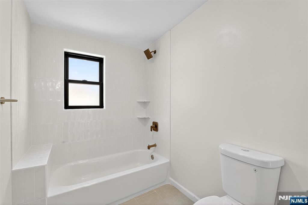 167 Harrison Avenue, Unit 3 Montclair, NJ 07042 - Photo 16 of 20 a bathroom with a bathtub and a toilet