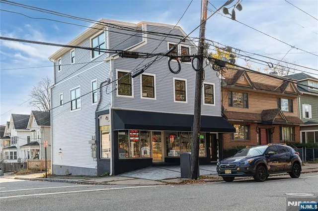 a car parked in front of a white building