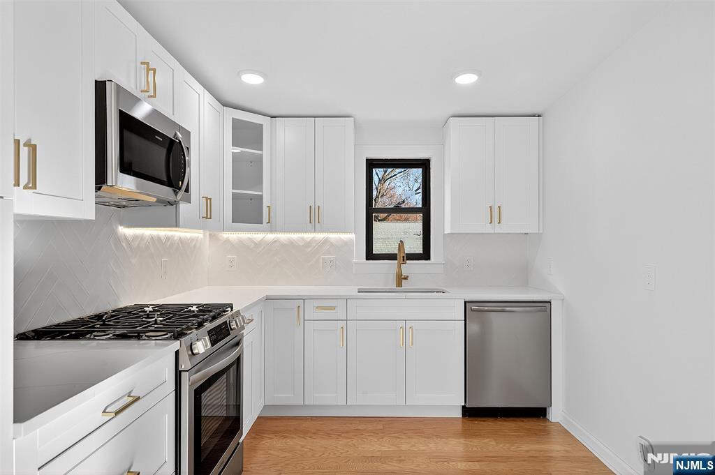 167 Harrison Avenue, Unit 3 Montclair, NJ 07042 - Photo 4 of 20 a kitchen with stainless steel appliances a sink dishwasher stove and microwave