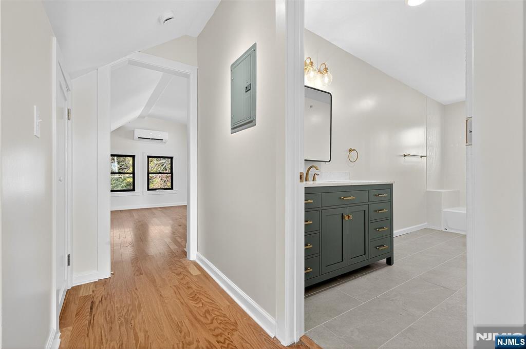 167 Harrison Avenue, Unit 3 Montclair, NJ 07042 - Photo 9 of 20 a view of a hallway with wooden floor and cabinet
