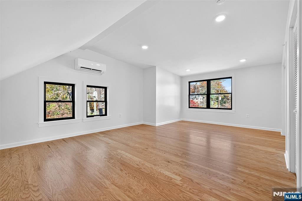 167 Harrison Avenue, Unit 3 Montclair, NJ 07042 - Photo 10 of 20 a view of an empty room with a window and wooden floor